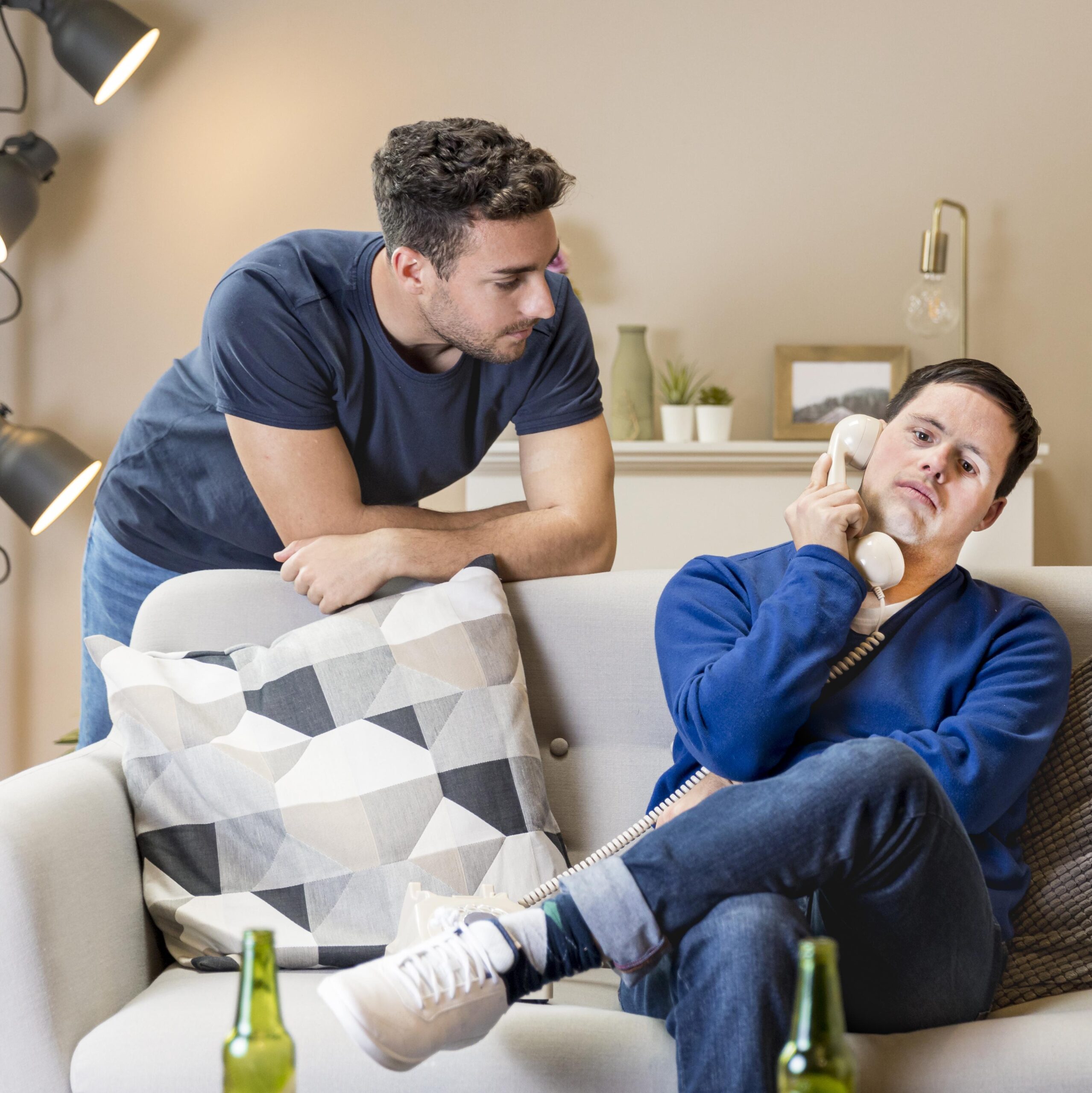 two-men-home-posing-with-telephone two-men-home-posing-with-telephone