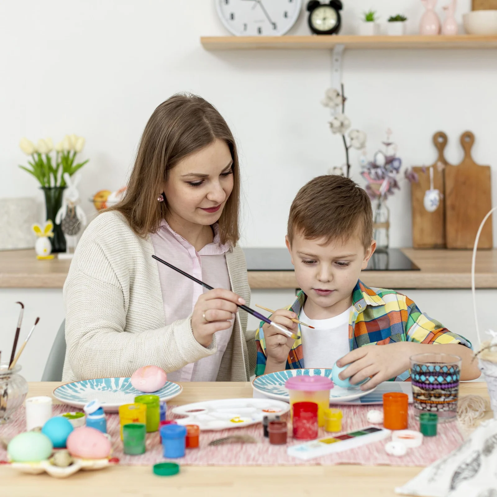 high-angle-mom-helping-son-paint-eggs high-angle-mom-helping-son-paint-eggs